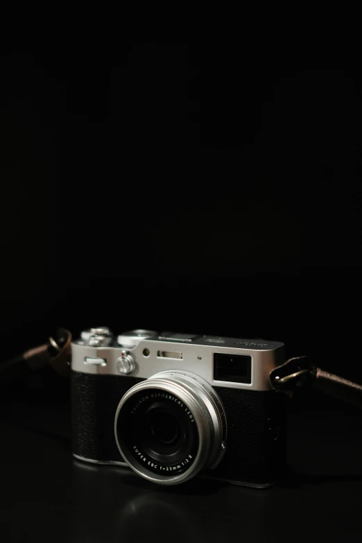 a camera with the lens facing slightly down on a black background