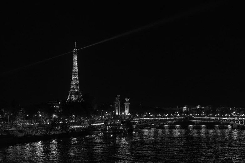 the eiffel tower towering over the city at night