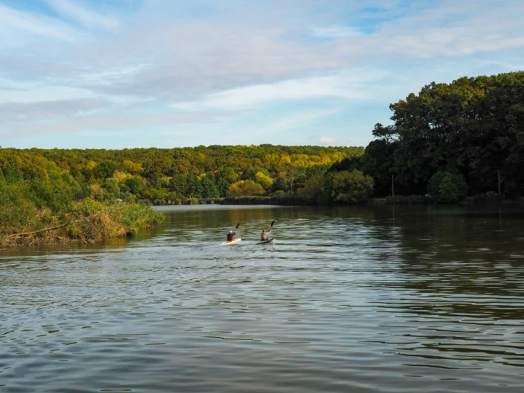 a person on a canoe in the middle of a lake