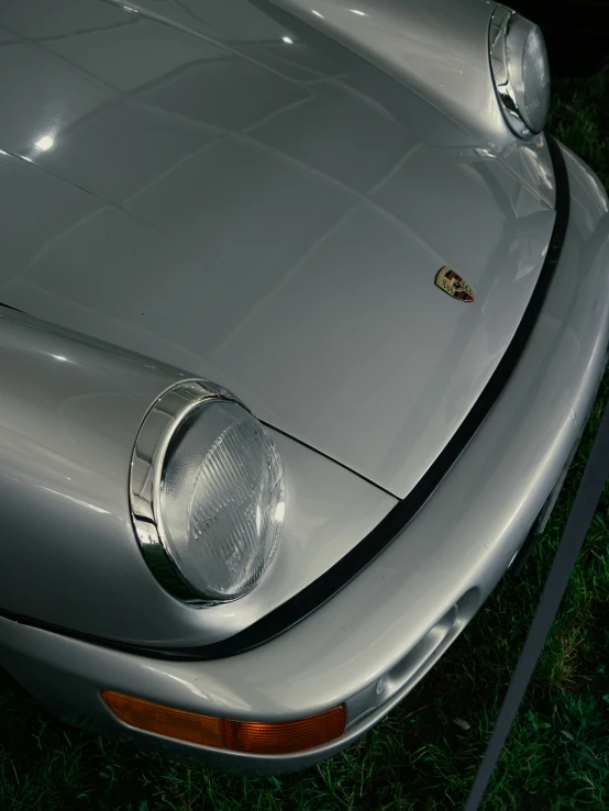 the front end of an old silver car