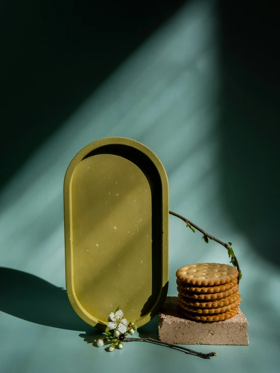 small round food dish placed next to three cookies