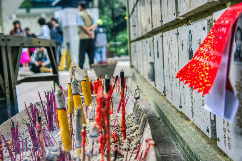 some red yellow and orange candles on some kind of stand