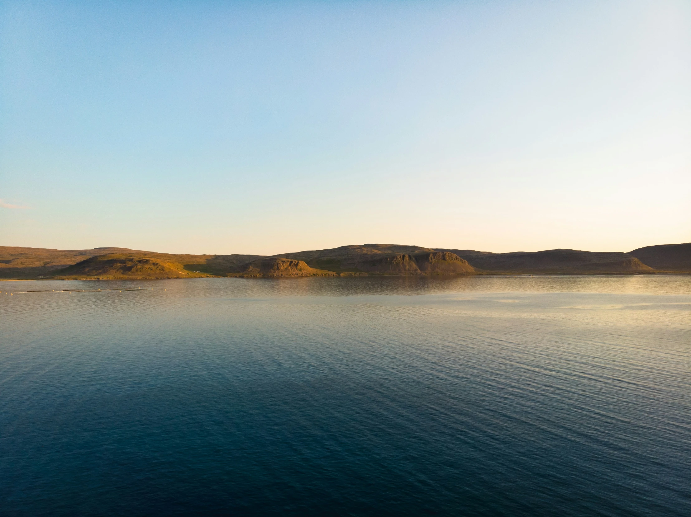 water is placid and blue under the clear sky