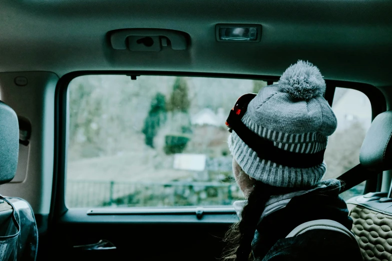 a person wearing a gray hat in a truck