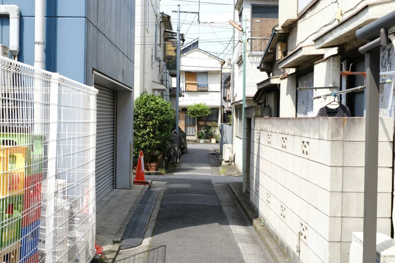 an empty alley in an urban area with a gate