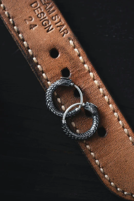 three ring leather band laying on a piece of brown