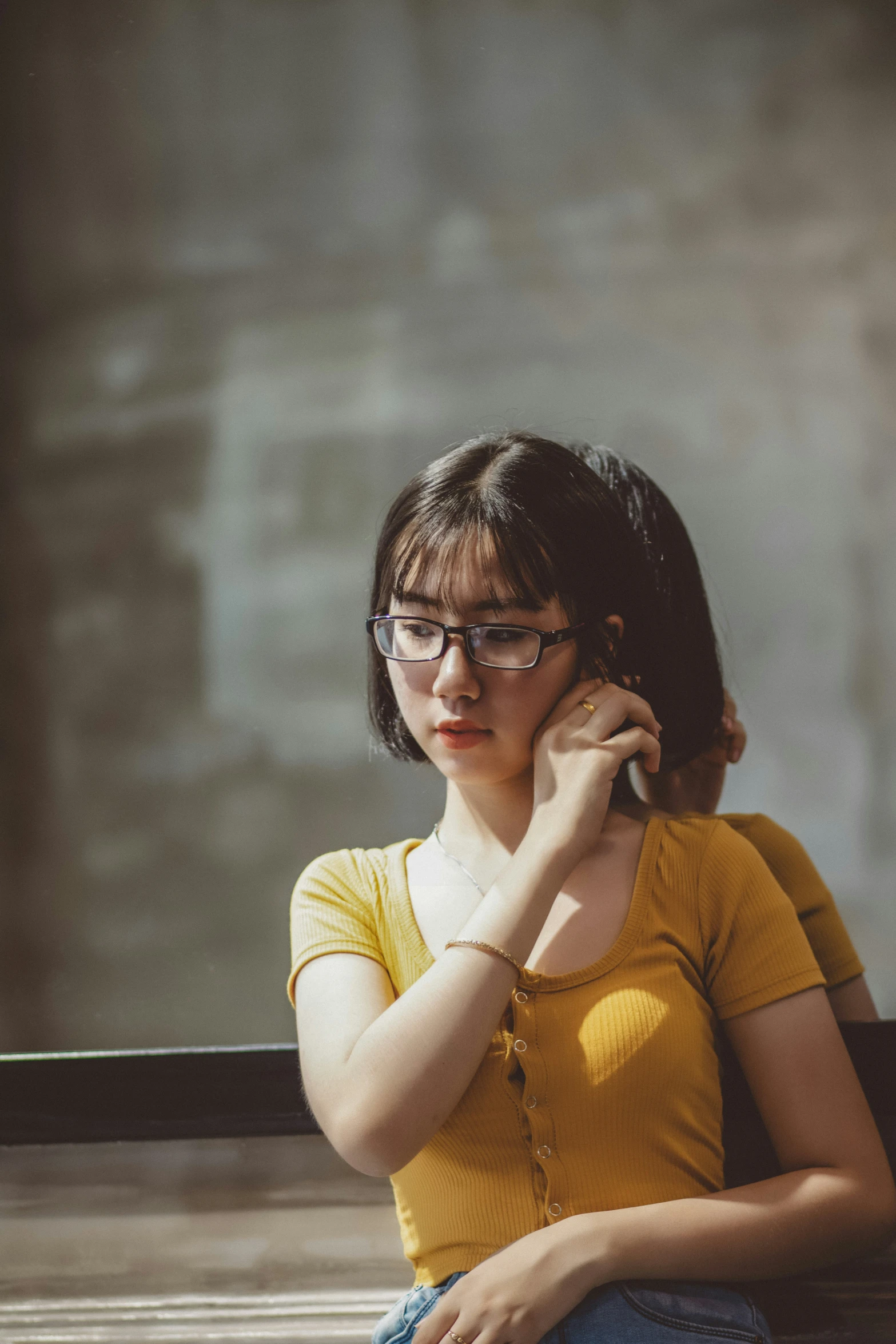 a woman wearing glasses and talking on a cell phone