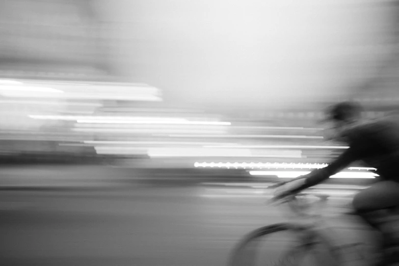 blurry image of man on bike in street