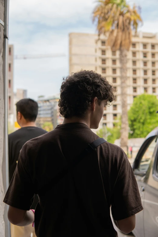 two men walking past a building that has been damaged