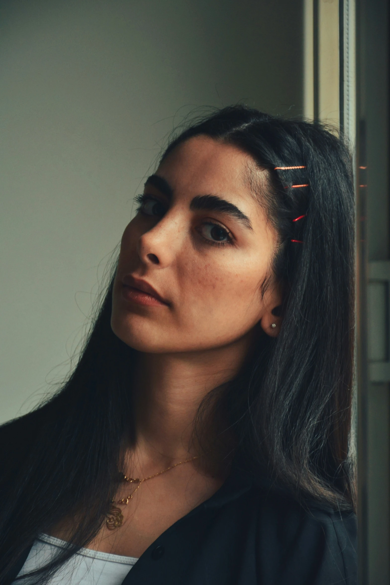 woman with makeup on top, black hair, and eyeliner strips