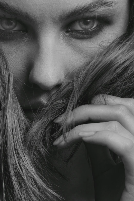 a woman with long hair and a mustache in black and white