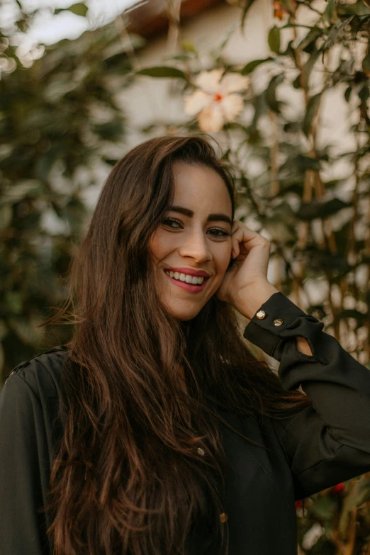 a woman with long brown hair talking on the phone