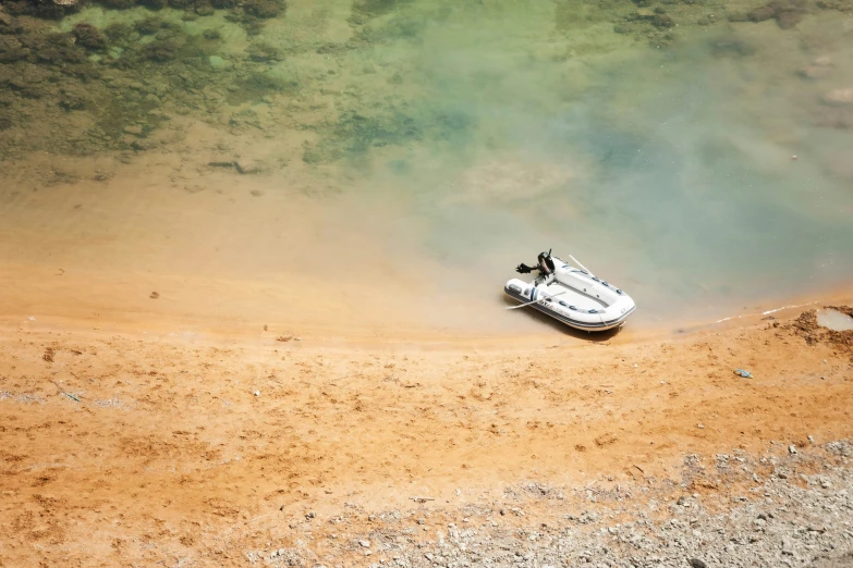 a small boat floating in the middle of an empty lake