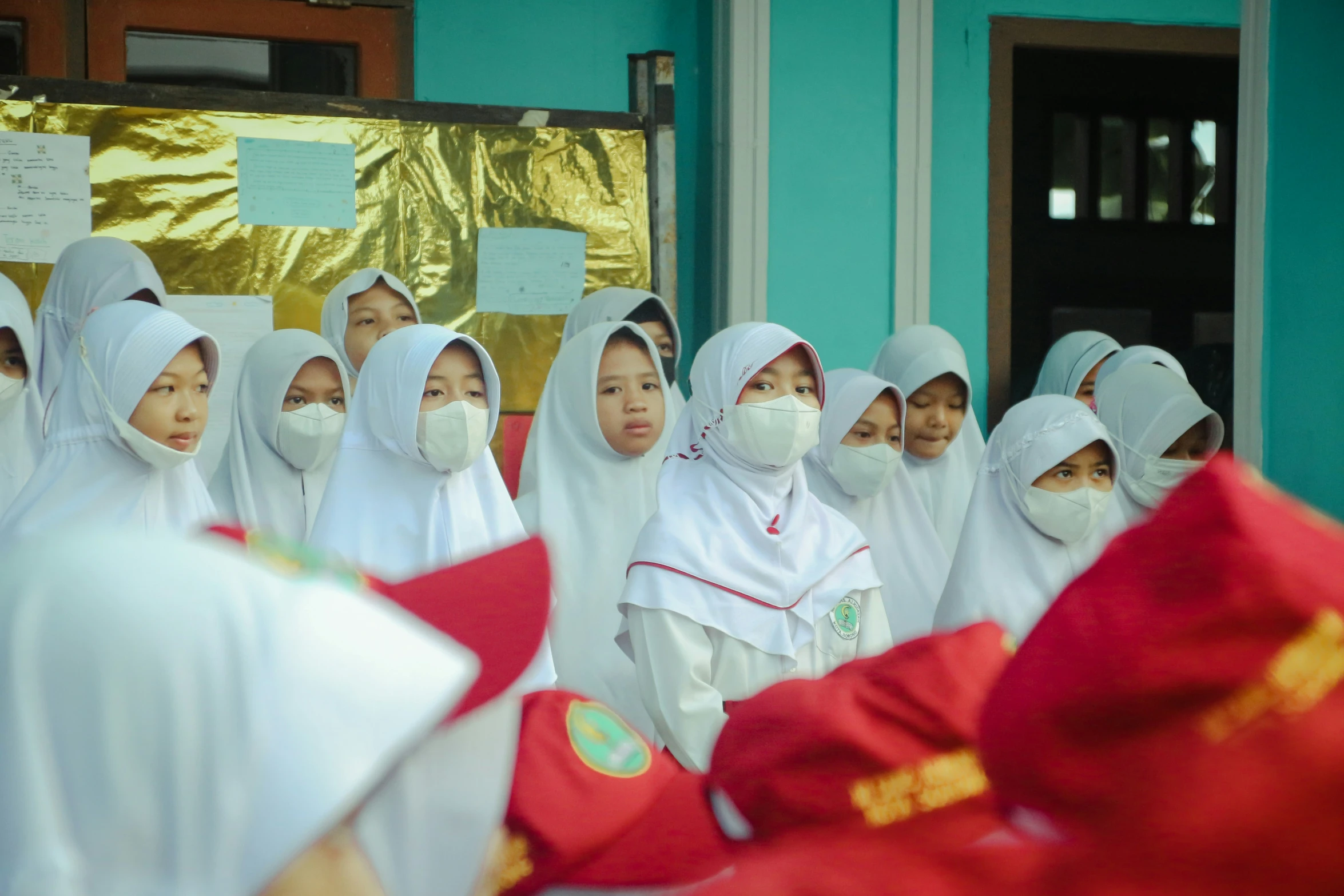 a group of asian children wearing masks