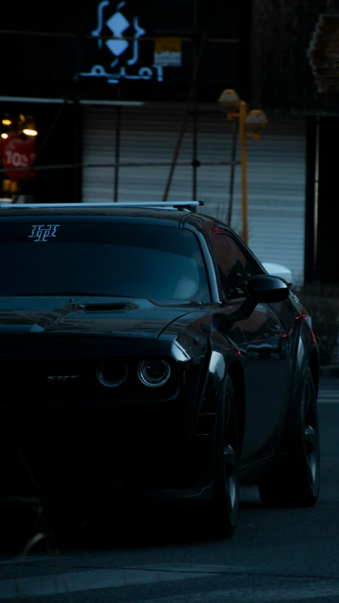 a car with its trunk up in the street