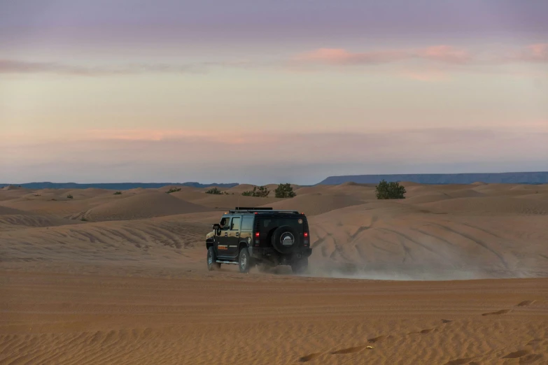 there is a vehicle that is going down the desert