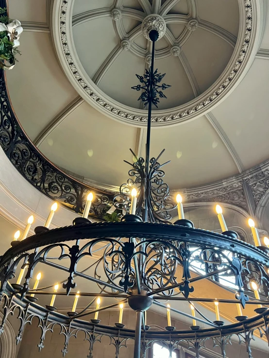 the ceiling chandelier is surrounded by candles