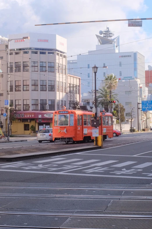 an old fashioned tram going down the city street