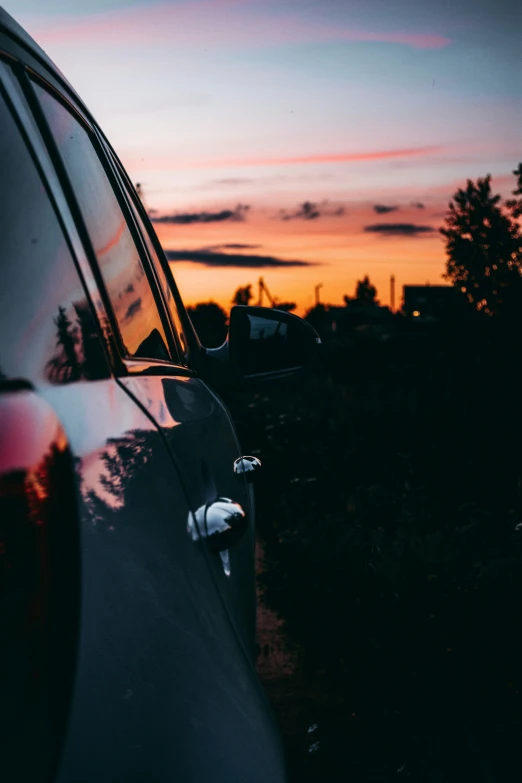 a sunset view from the outside of a car