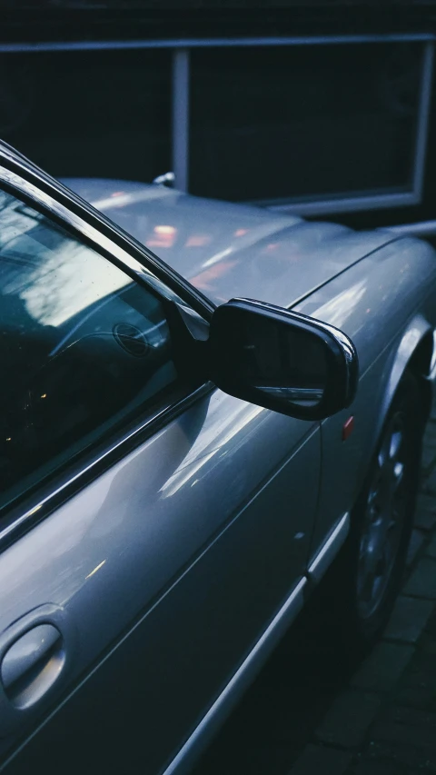 a car is parked on the side of the street at night