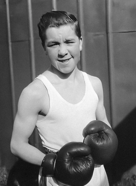 a black and white po of a boy wearing boxing gloves