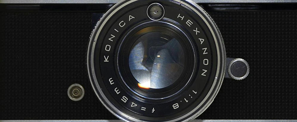 an analog camera with the lens focused to the camera