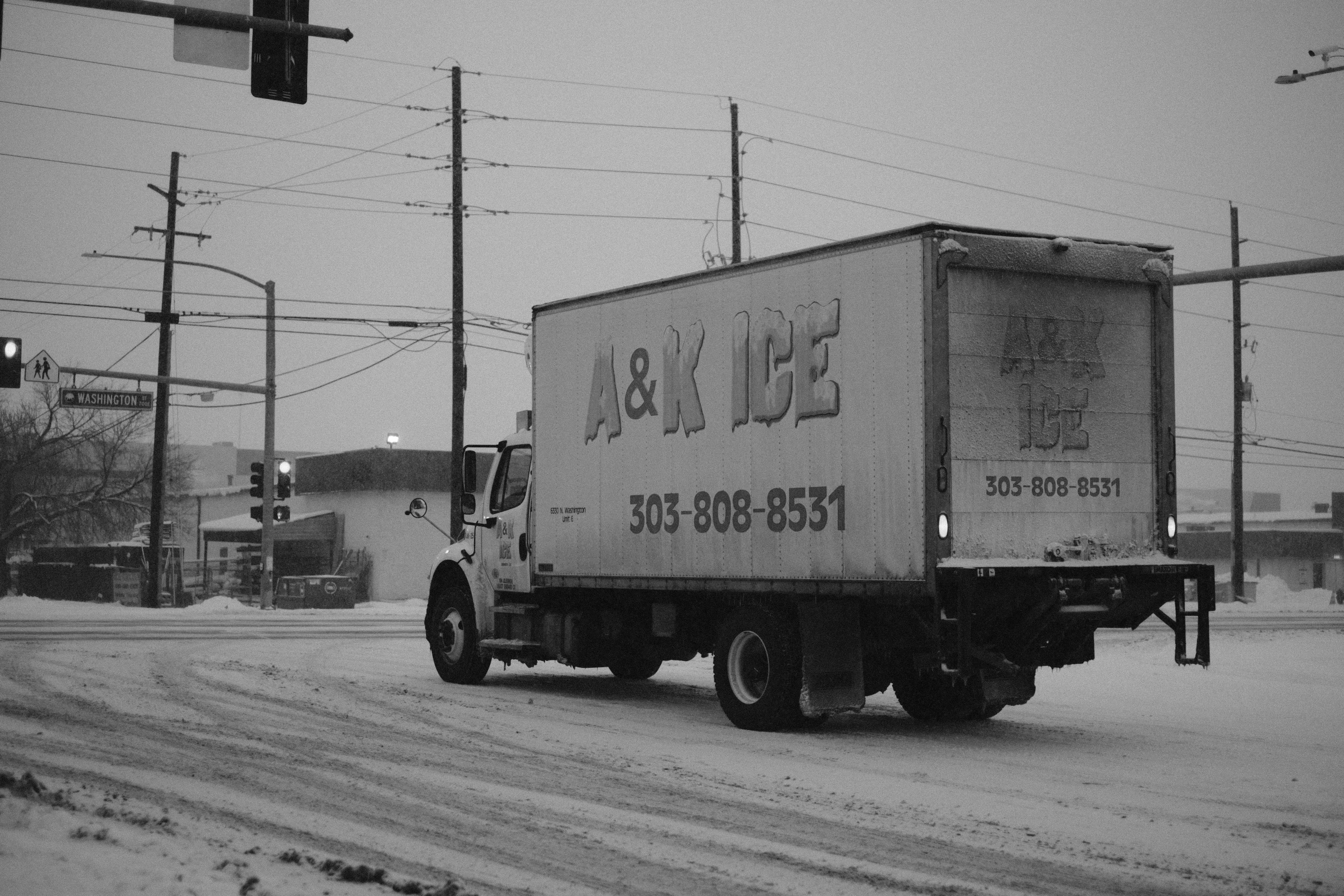 a large truck is traveling down the snowy road