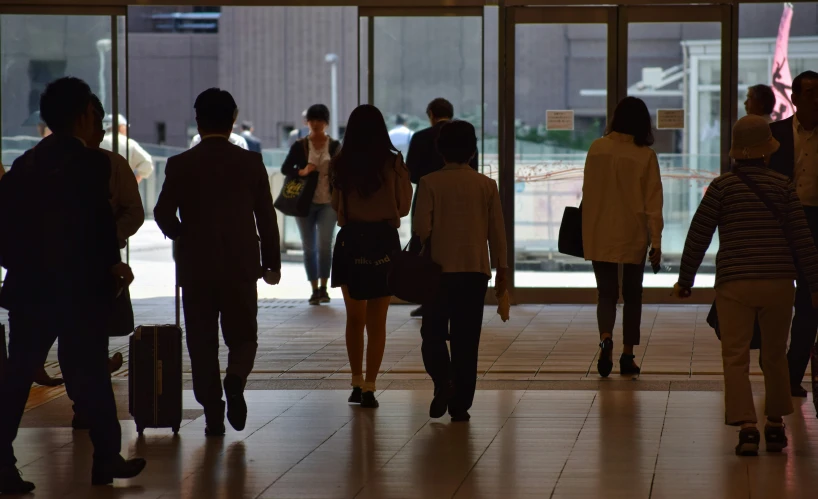 a group of people walking inside of an airport