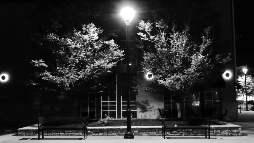 a large black and white pograph of the outside of a building at night