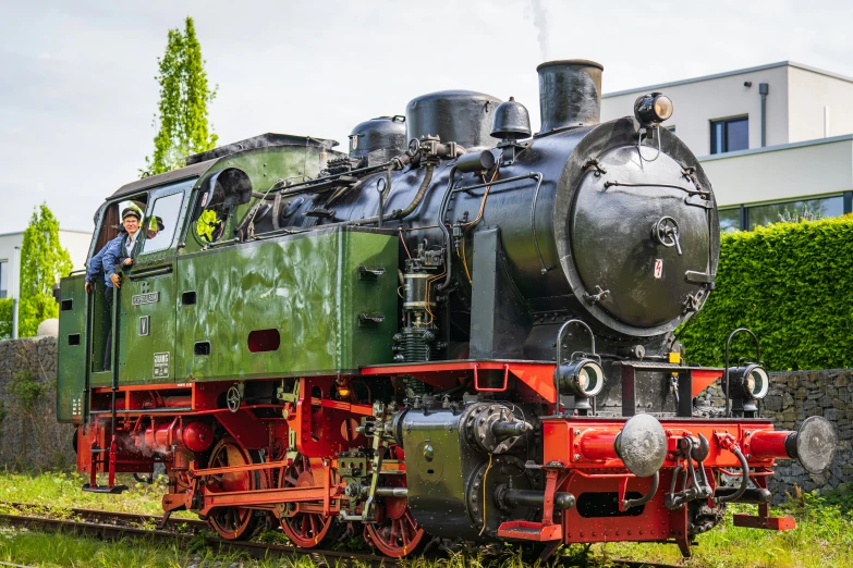 an old train sits on the track with its driver