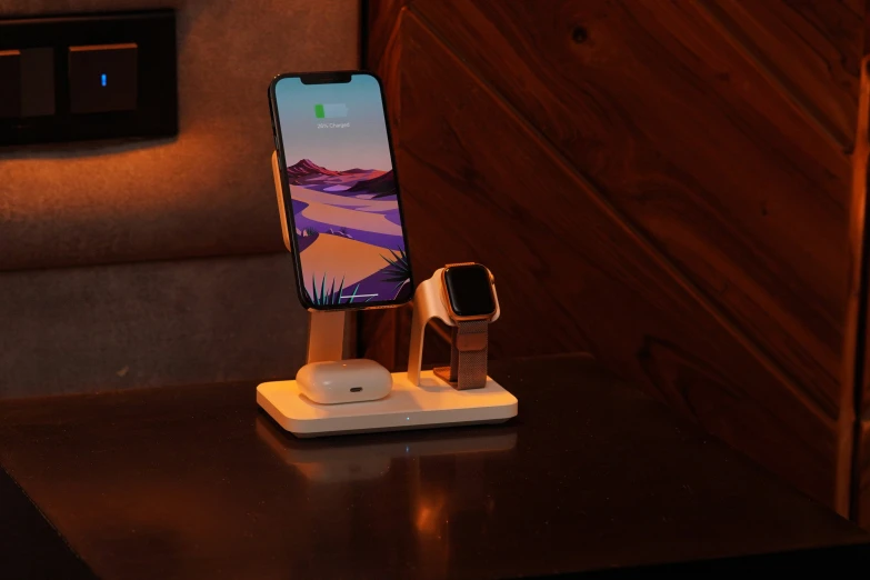 a phone, cellphone and charger are on a stand