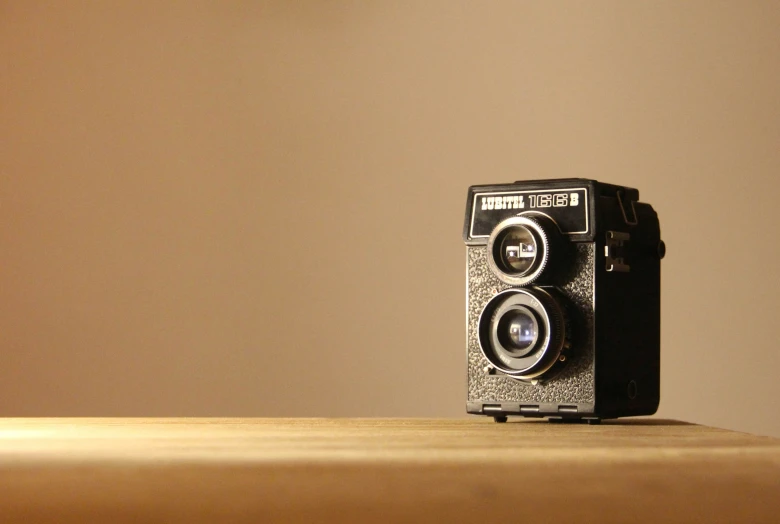 a very old camera on a table with room for text