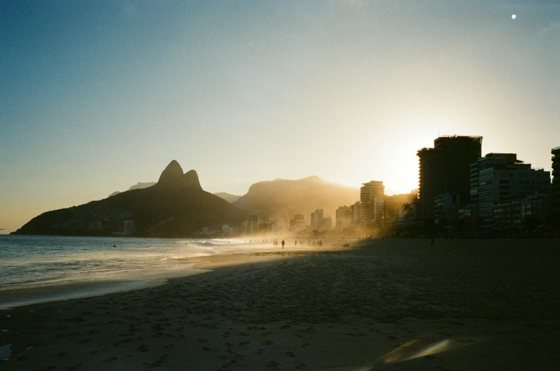 a beach is shown at sunset in a city