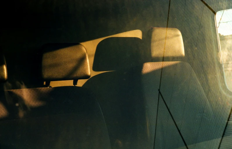 a mirror image from inside a car shows a line of seats