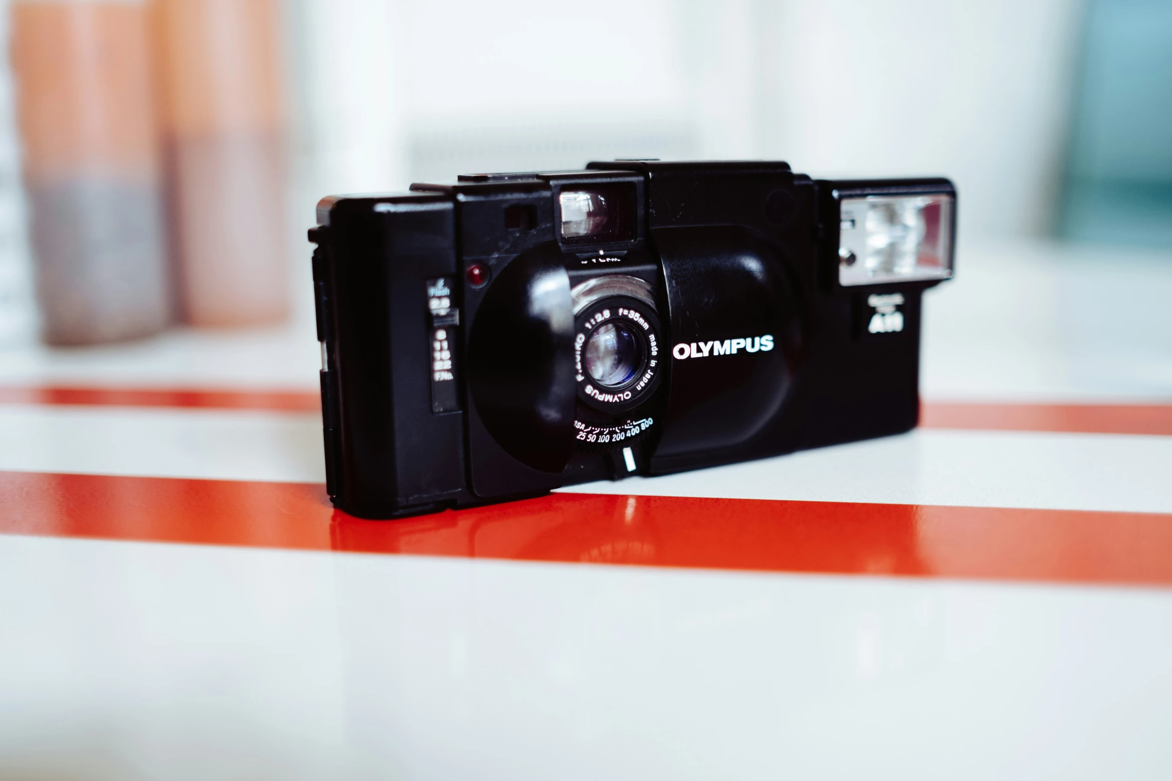 a camera sitting on top of a red and white striped table