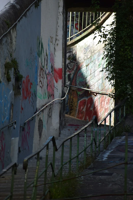 an abandoned building that has stairs painted with spray paint