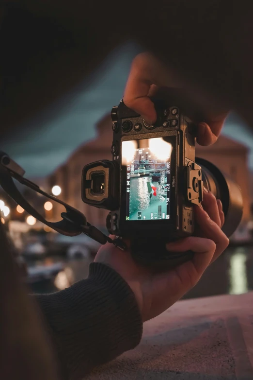 someone taking a picture with their camera of the river