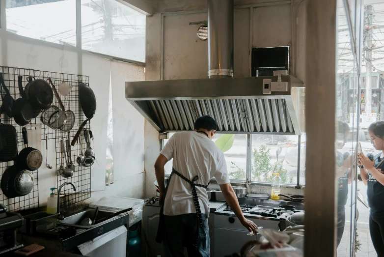 a person wearing a mask cooking in a kitchen