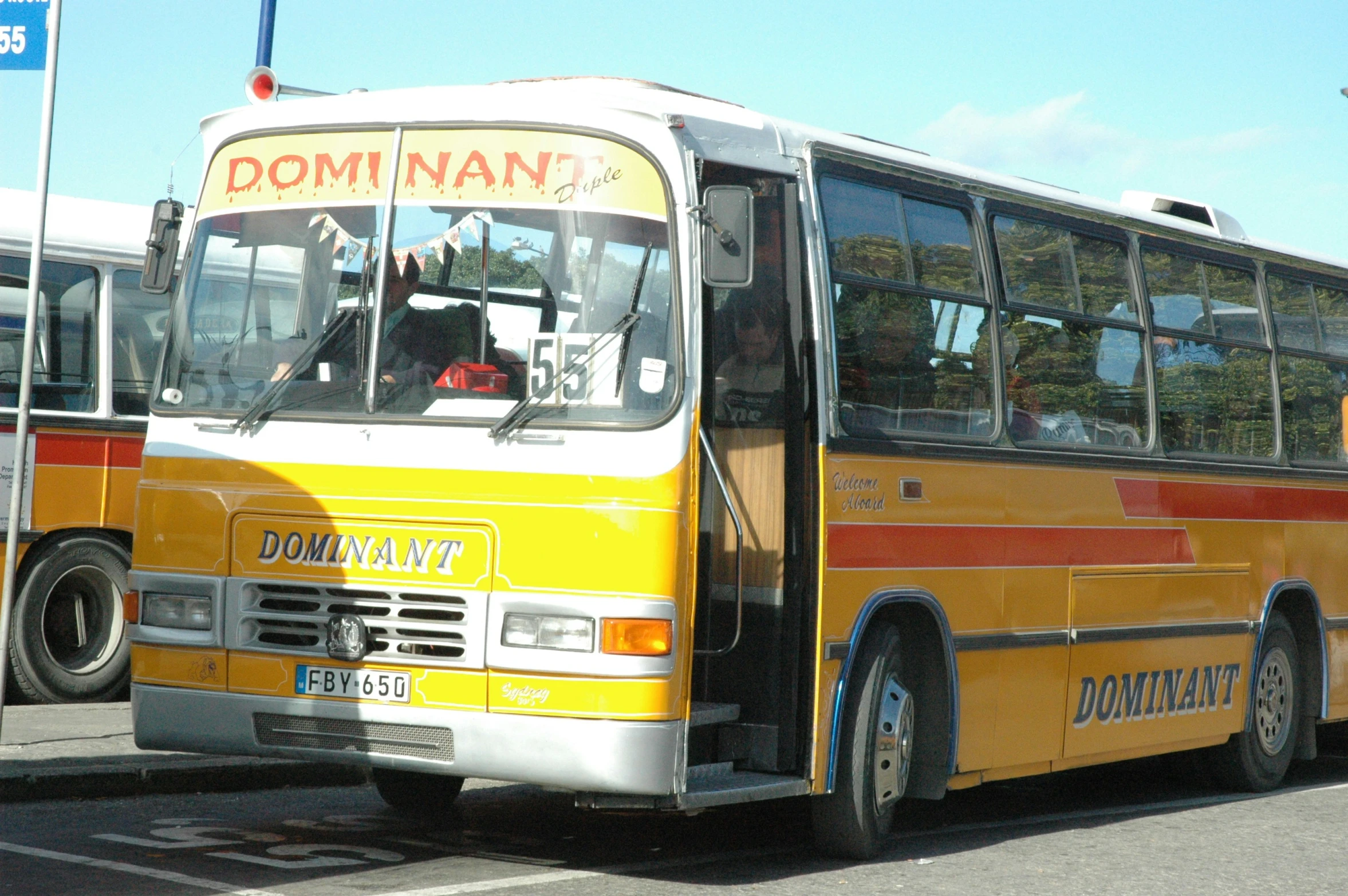 a yellow and white bus on the street