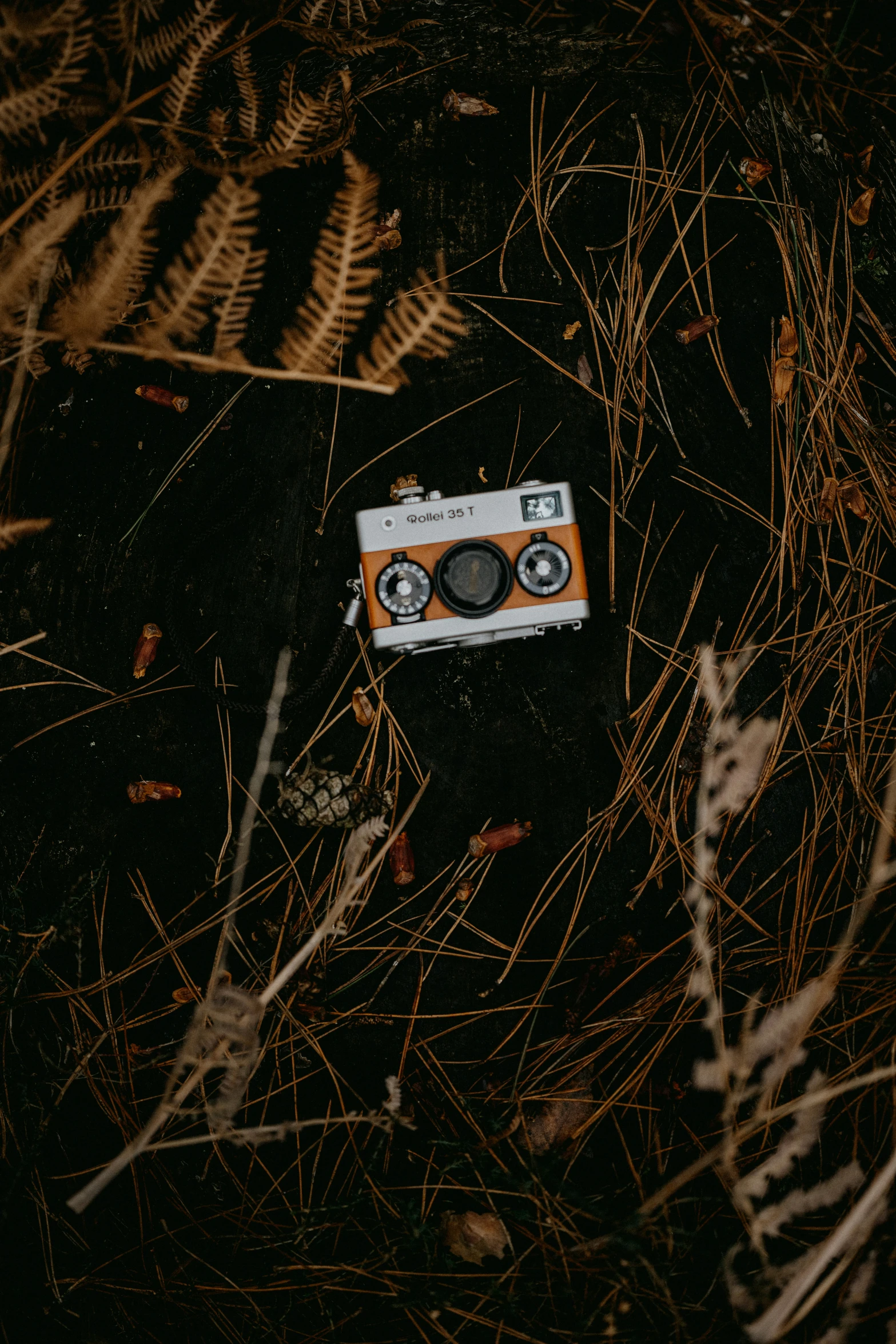 the orange and white toy case lies on the ground