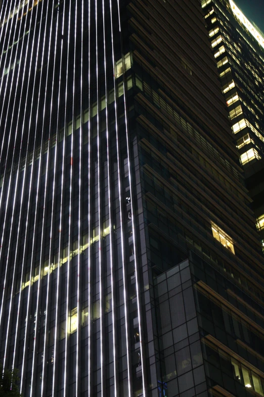 the top of a skyscr with windows lit up in the night