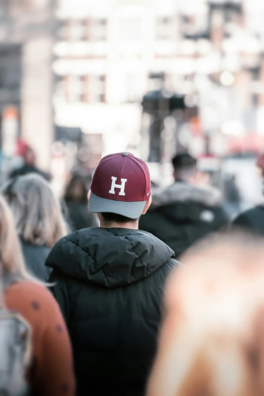 a boy wearing a hat that reads h