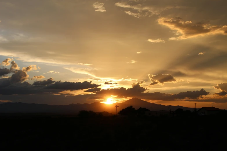 the sun is setting behind some mountains