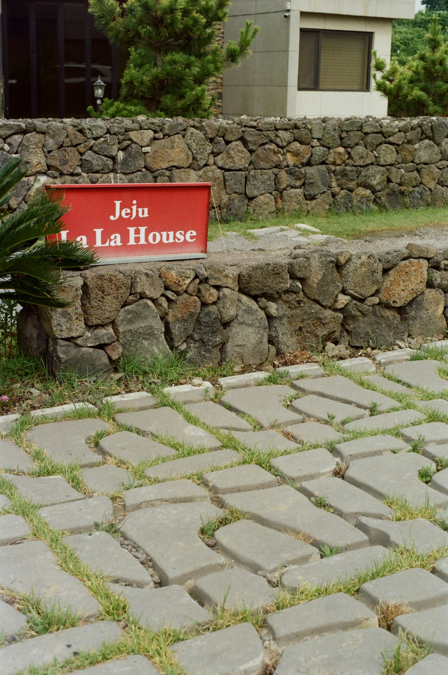 the entrance of an old stone building has a red sign saying