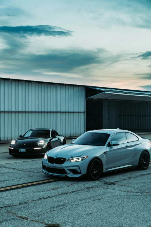 two cars sitting next to each other in a parking lot