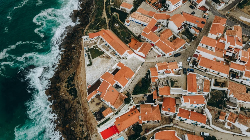 an aerial view of a small town by the sea