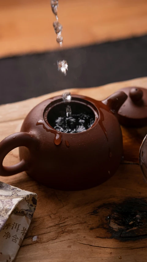 a black coffeepot with water in it and some napkins