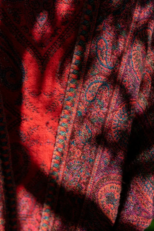 a sweater pattern is red with some blue and pink colors