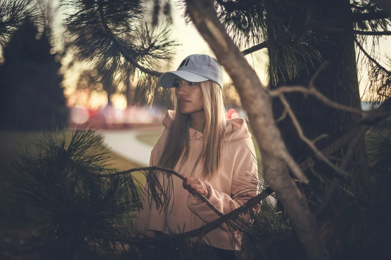 a  is standing in a park by some trees