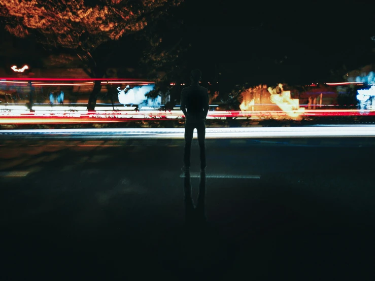 a man standing next to a pole with trees near him